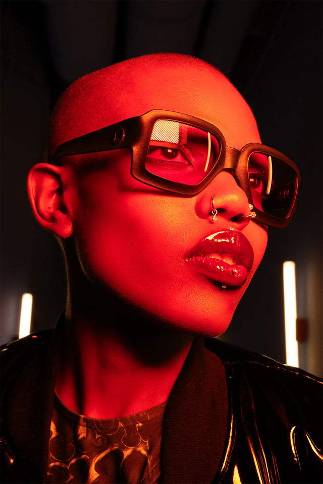 Female model with bold square black sunglasses by REFRAMD, high fashion look