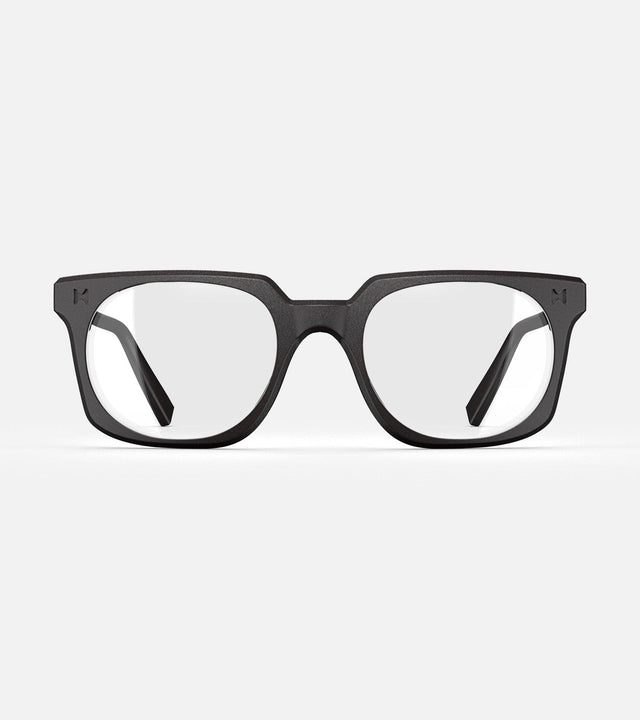 Black square-frame glasses with clear lenses, designed with an inclusive fit for all nose bridges, featuring a modern minimalist design