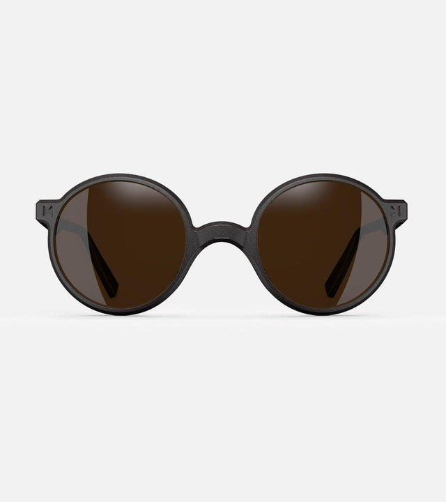Round black 3D-printed glasses with dark lenses are designed for an excellent fit across various nose profiles. Offering stylish and comfortable option for those seeking unique and customizable eyewear.
