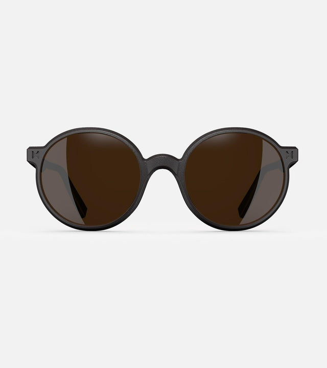 Round black 3D-printed glasses with dark lenses are designed for an excellent fit across various nose profiles. Offering stylish and comfortable option for those seeking unique and customizable eyewear.