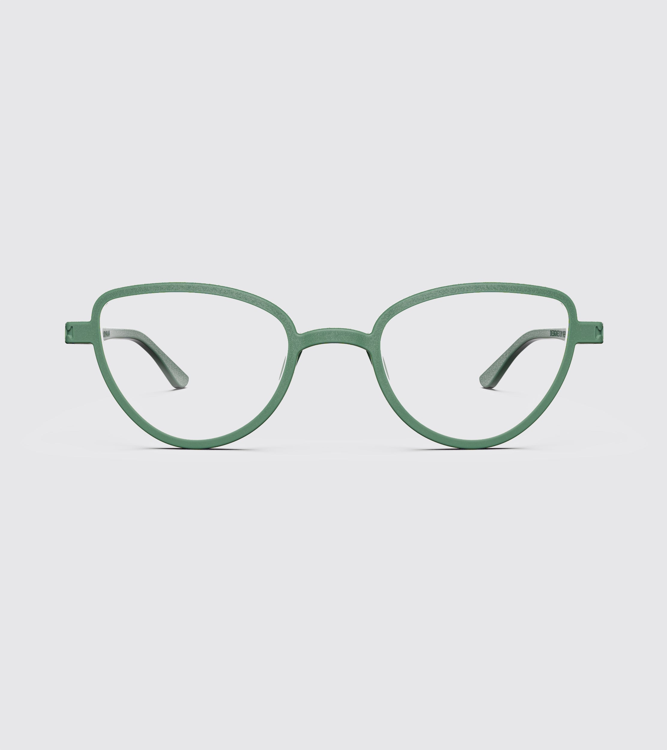 Green eyeglasses on a light gray background