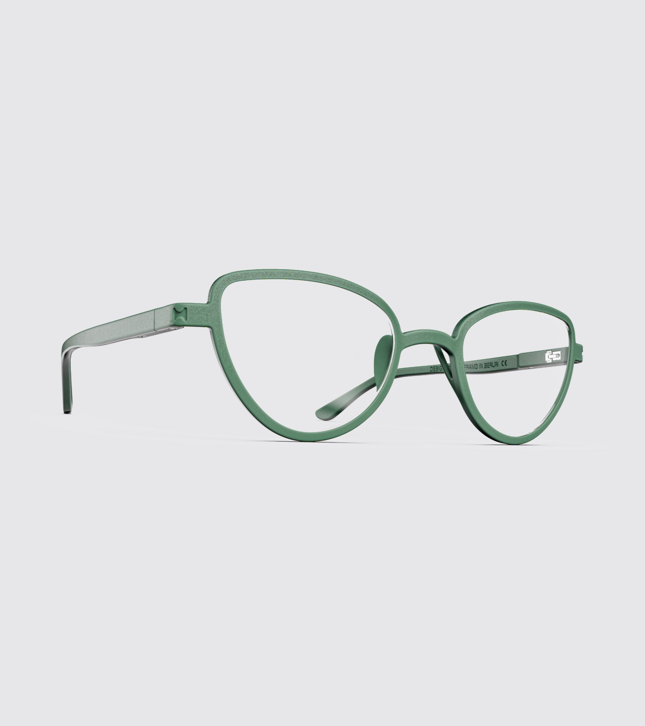 Green eyeglasses on a light gray background