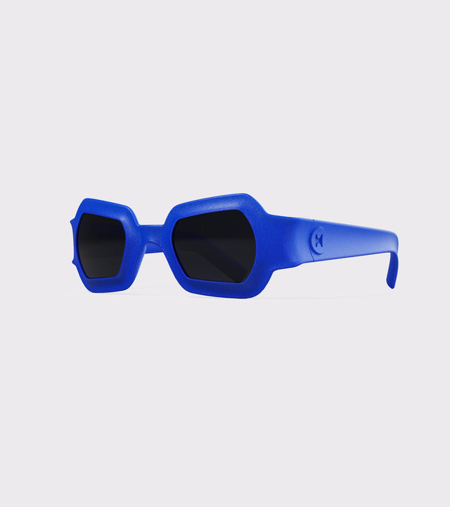 Bold blue 3D printed sunglasses with unique geometric frames and dark lenses, designed for an excellent fit across different nose profiles