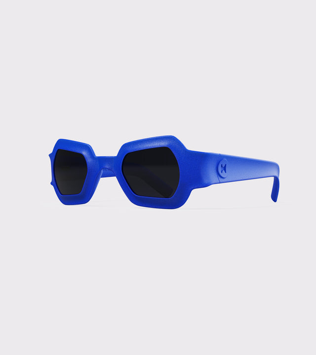 Bold blue 3D printed sunglasses with unique geometric frames and dark lenses, designed for an excellent fit across different nose profiles