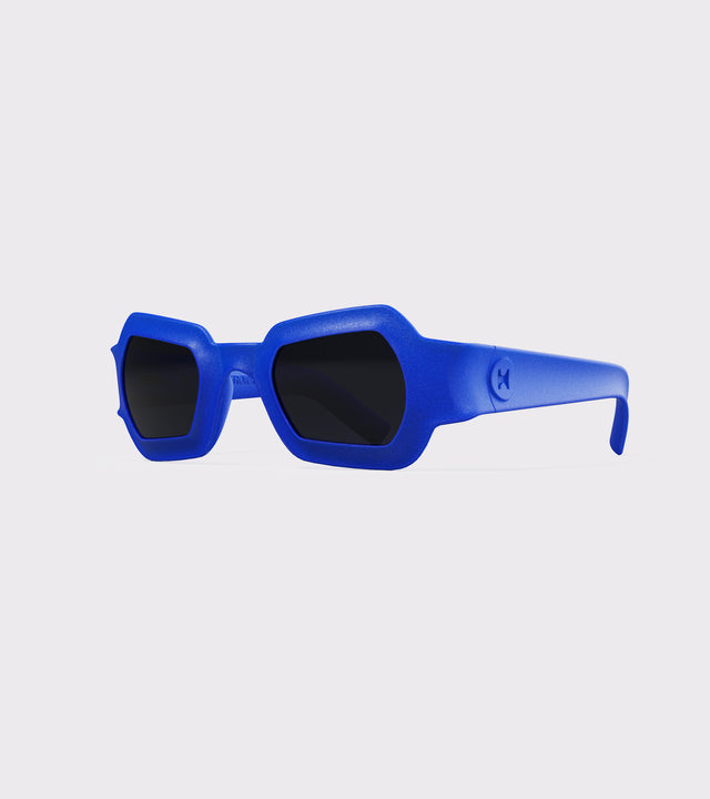 Bold blue 3D printed sunglasses with unique geometric frames and dark lenses, designed for an excellent fit across different nose profiles