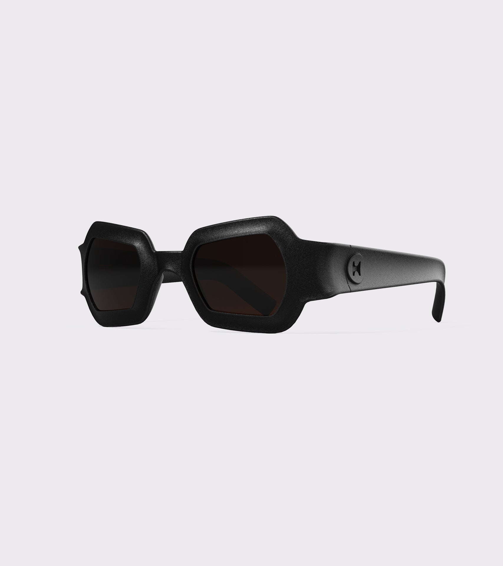 Bold black 3D printed sunglasses with unique geometric frames and dark lenses, designed for an excellent fit across different nose profiles