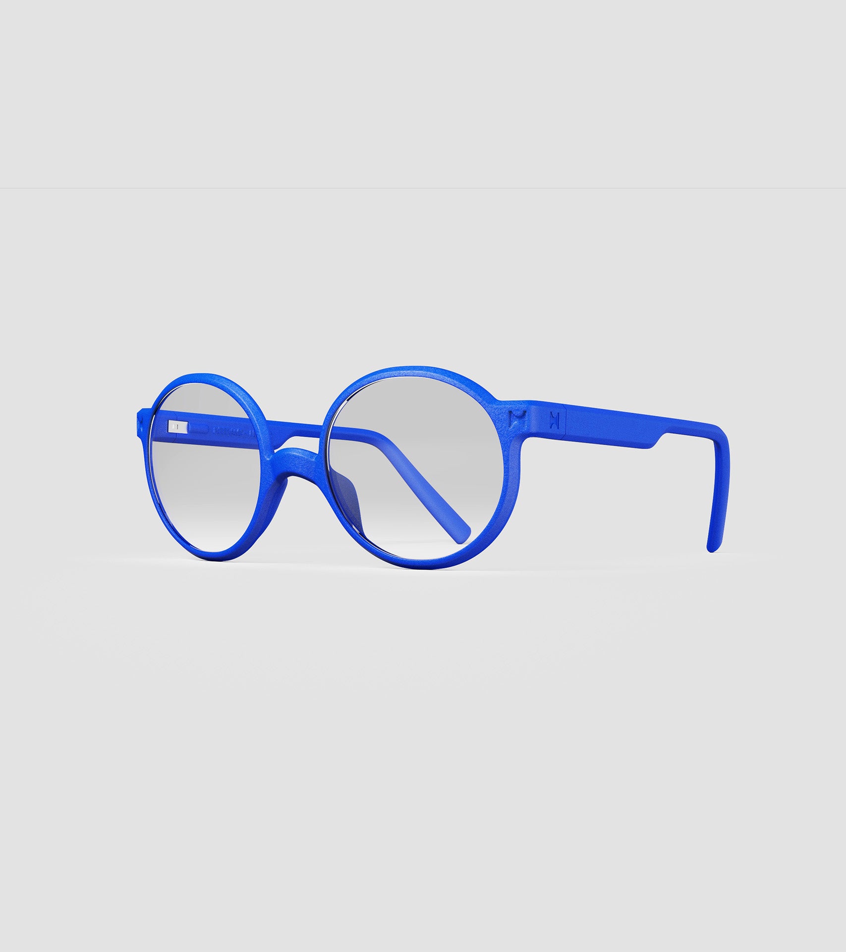 Round blue 3D-printed glasses with clear lenses are designed for an excellent fit across various nose profiles. Offering stylish and comfortable option for those seeking unique and customizable eyewear.