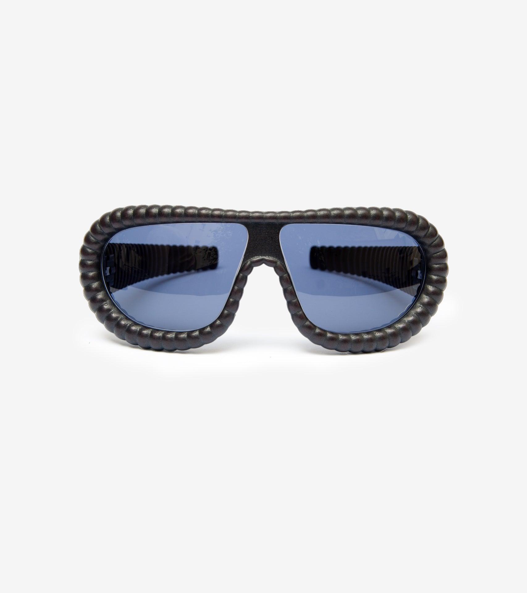 Fashion-forward gold ribbed sunglasses with brown lenses for a bold statement