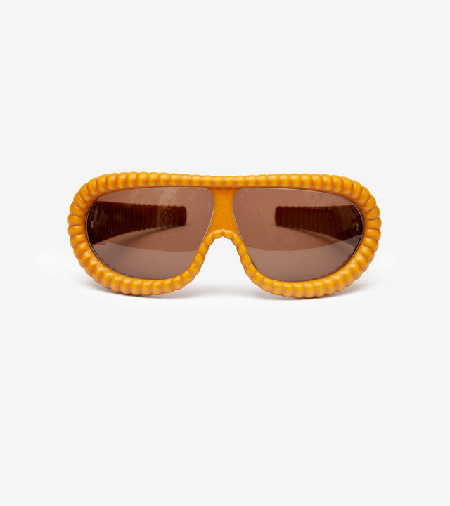 Modern gold ribbed sunglasses with brown lenses, combining luxury with innovative design