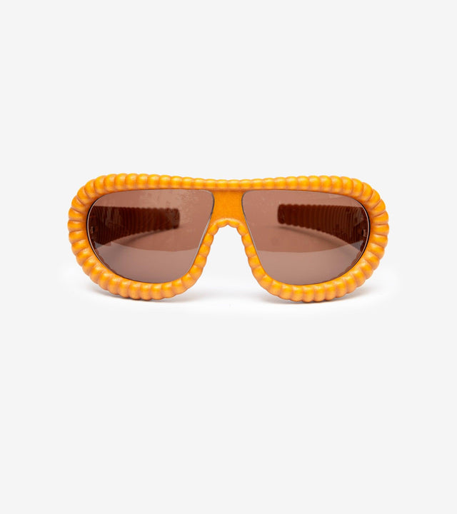 Fashion-week gold puffy sunglasses with brown lenses for a bold statement