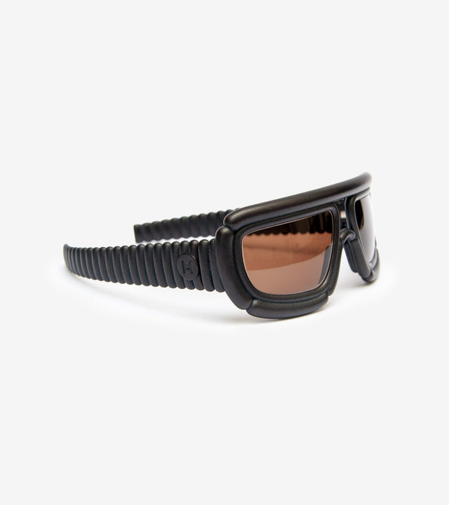 Stylish black sunglasses with unique padded frame, combining comfort and cutting-edge design