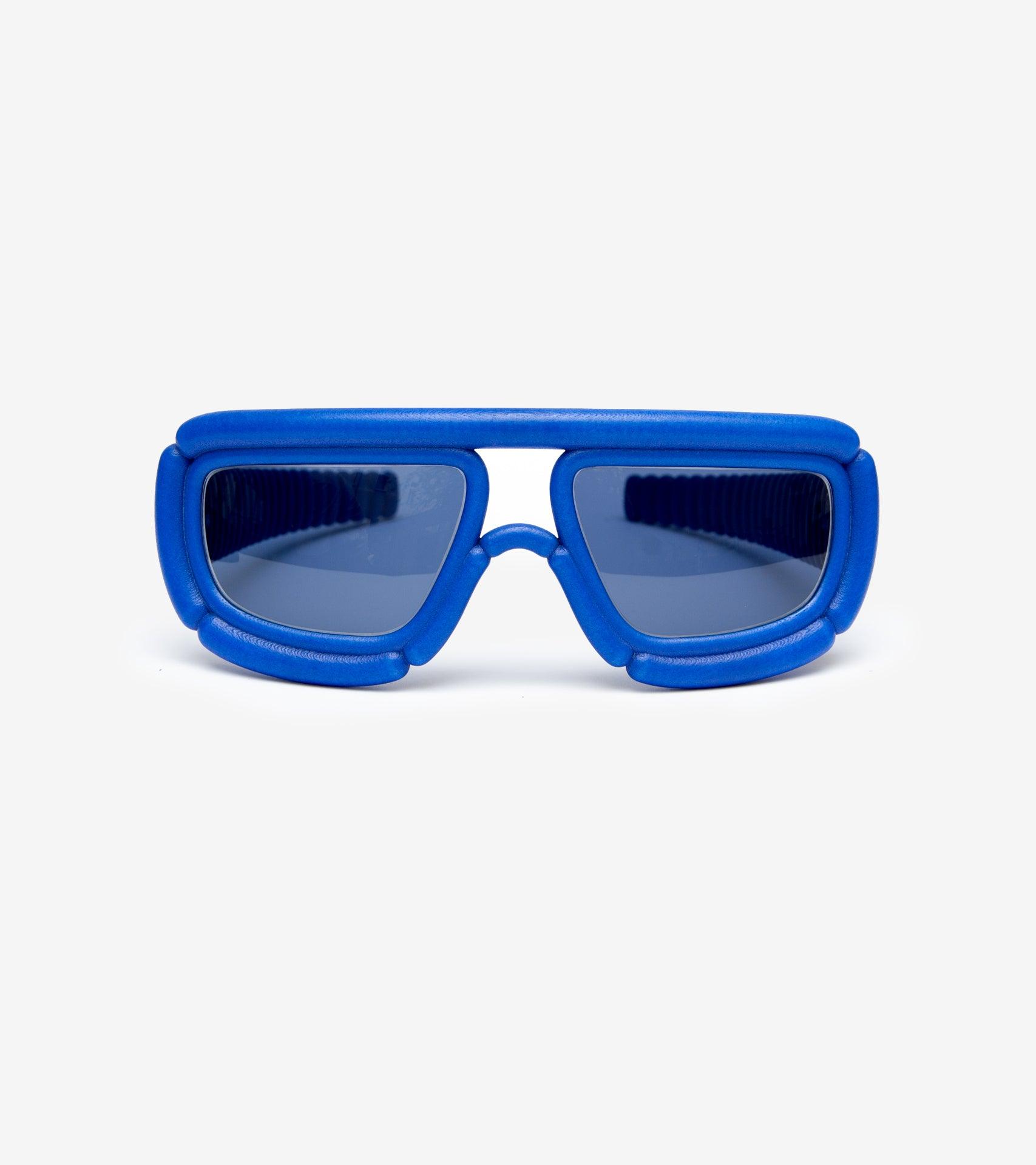 Bold blue sunglasses with padded frames, designed for a unique and contemporary aesthetic