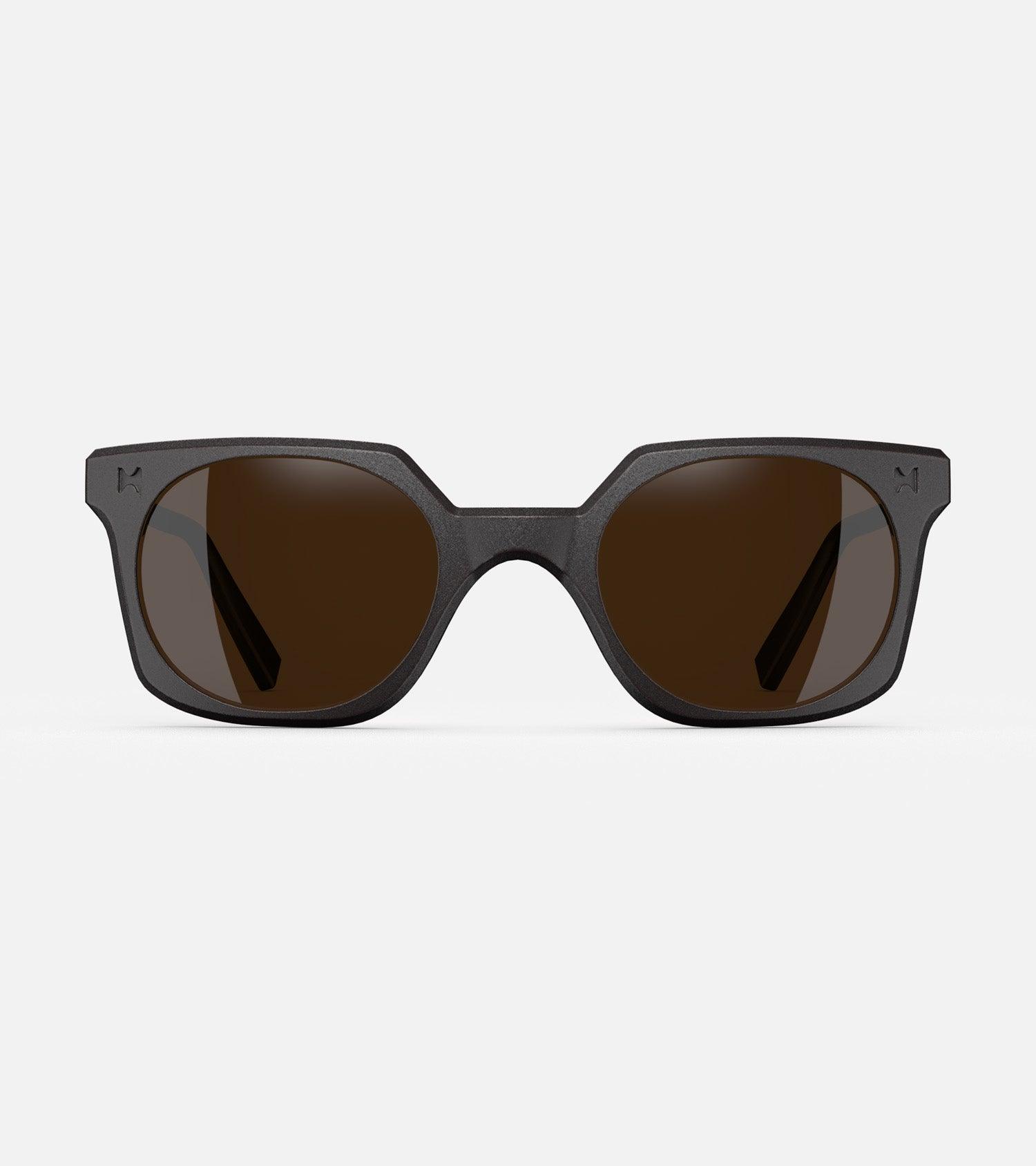 Black square-frame glasses with dark lenses, designed with an inclusive fit for all nose bridges, featuring a modern minimalist design