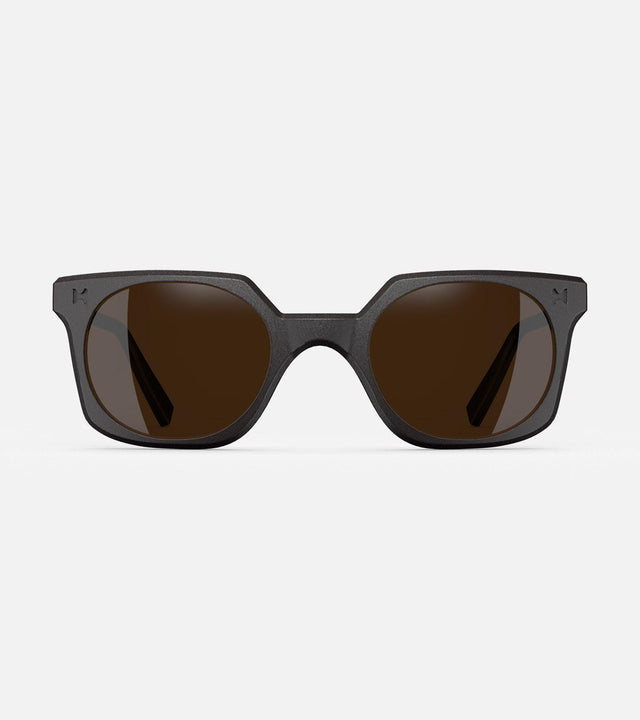 Black square-frame glasses with dark lenses, designed with an inclusive fit for all nose bridges, featuring a modern minimalist design