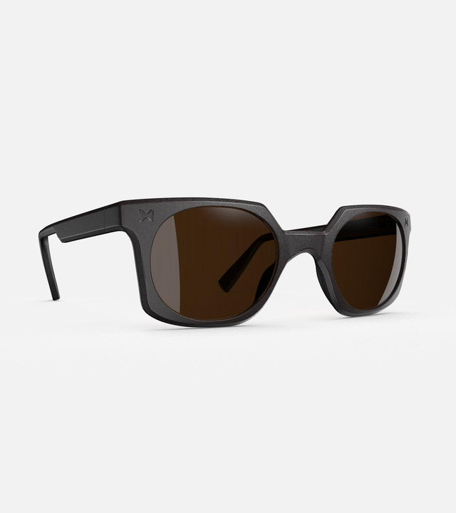 Black square-frame glasses with dark lenses, designed with an inclusive fit for all nose bridges, featuring a modern minimalist design