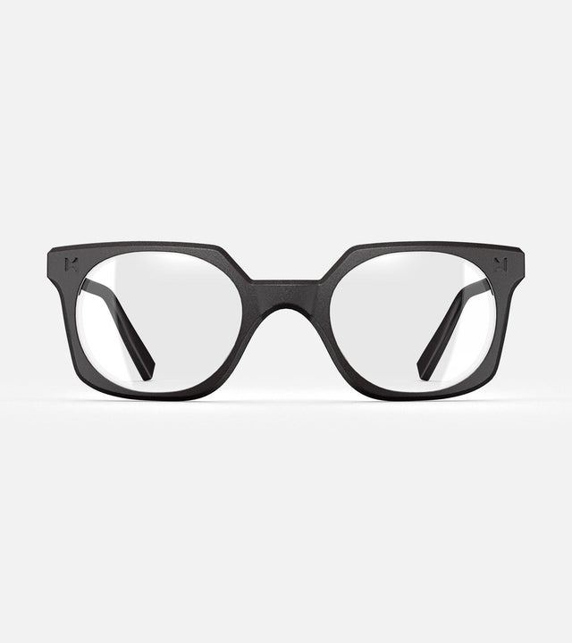 Black square-frame glasses with clear lenses, designed with an inclusive fit for all nose bridges, featuring a modern minimalist design