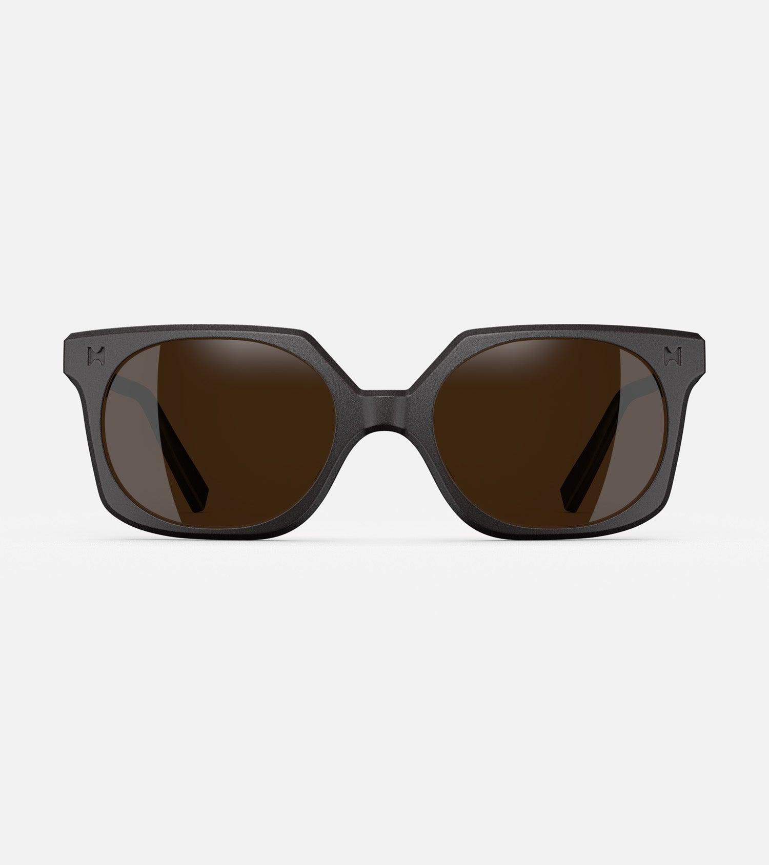 Black square-frame glasses with dark lenses, designed with an inclusive fit for all nose bridges, featuring a modern minimalist design