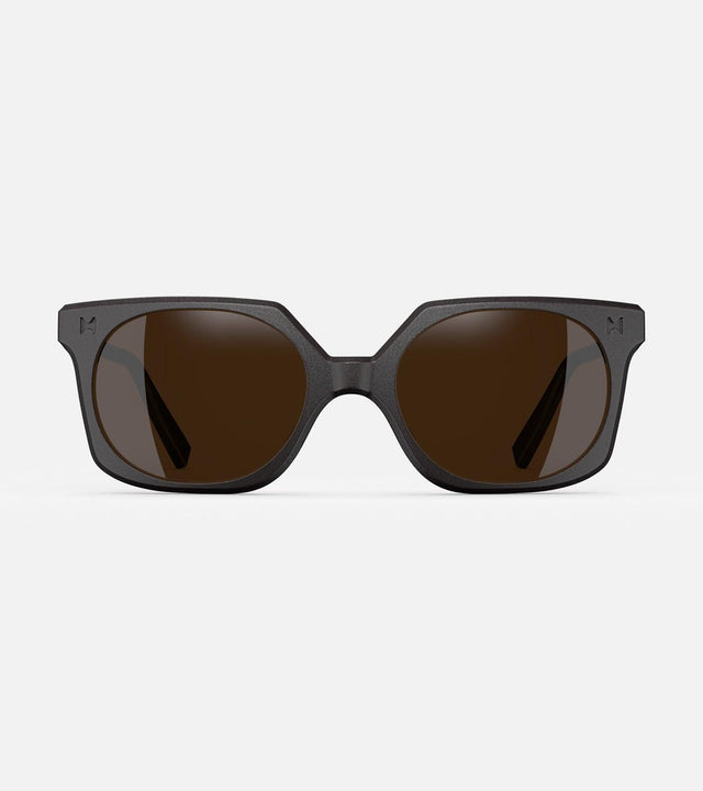Black square-frame glasses with dark lenses, designed with an inclusive fit for all nose bridges, featuring a modern minimalist design