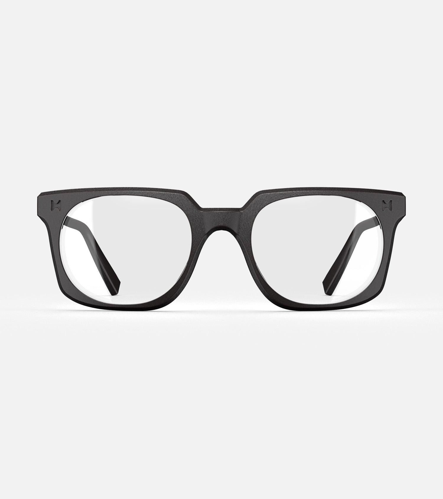 Black square-frame glasses with clear lenses, designed with an inclusive fit for all nose bridges, featuring a modern minimalist design