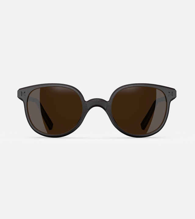 Modern black framed sunglasses with round brown lenses for wide nose bridges