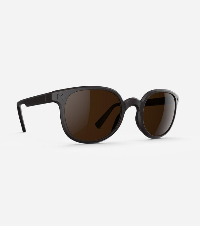 Modern black framed sunglasses for narrow nose bridges with round brown lenses