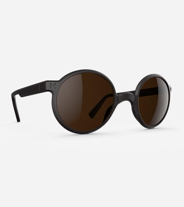 Round black 3D-printed glasses with dark lenses are designed for an excellent fit across various nose profiles. Offering stylish and comfortable option for those seeking unique and customizable eyewear.