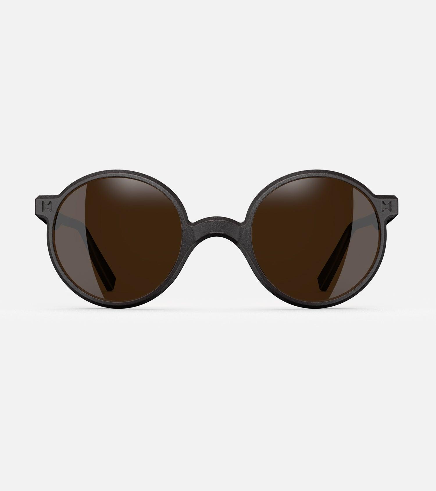 Round black 3D-printed glasses with dark lenses are designed for an excellent fit across various nose profiles. Offering stylish and comfortable option for those seeking unique and customizable eyewear.