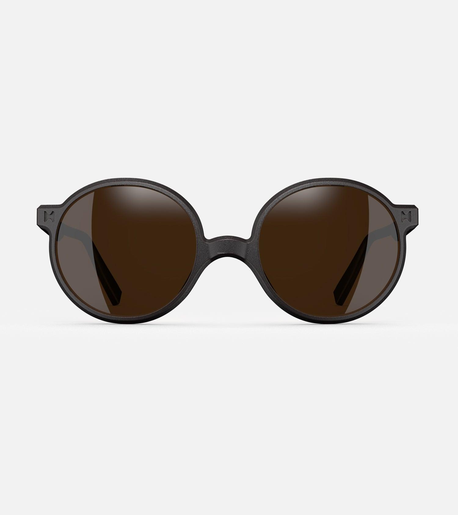 Round black 3D-printed glasses with dark lenses are designed for an excellent fit across various nose profiles. Offering stylish and comfortable option for those seeking unique and customizable eyewear.