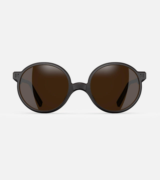 Round black 3D-printed glasses with dark lenses are designed for an excellent fit across various nose profiles. Offering stylish and comfortable option for those seeking unique and customizable eyewear.